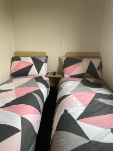 two beds sitting next to each other in a room at Jan' Sea View Getaway in Heysham +58 photos