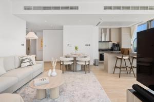 a living room with a couch and a table at Marina Gate Luxury Full Marina & Sunset Sea Views in Dubai