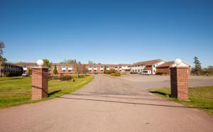 an empty road in a residential neighborhood with houses at Dutch Inn in Cornwall