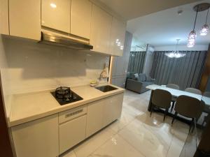 a kitchen with a sink and a table in a room at Sky House BSD in Samporo