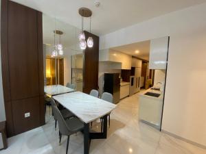 a dining room and kitchen with a table and chairs at Sky House BSD in Samporo