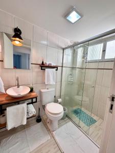 a bathroom with a shower and a toilet and a sink at Barriga Verde in Florianópolis