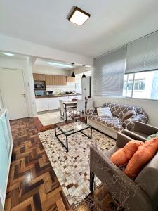 a living room with a couch and a table at Barriga Verde in Florianópolis