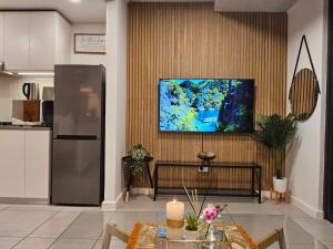 a living room with a television on a wall at Sibaya's Premium Apartment in Coral Point in Sibaya