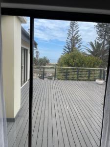 a view of a deck from a window of a house at The Beach Residence in Swakopmund