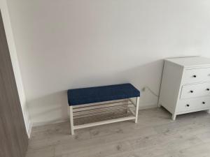 a stool with a blue seat next to a dresser at Lora - Tsarevo in Tsarevo