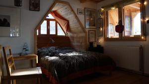 a bedroom with a large bed in a attic at Valea Vinului Suite in Vişeu de Sus