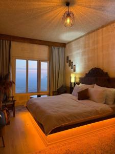 a bedroom with a large bed and a large window at İnaros Hotel in Mardin +10 photos