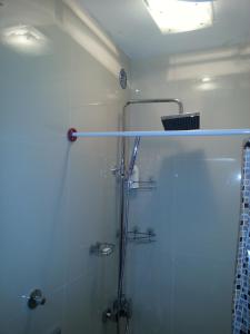 a bathroom with a shower with a glass door at Apartment 9 Gorska Vila in Zlatibor +32 photos