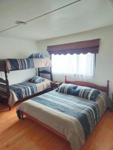 Postel nebo postele na pokoji v ubytování Hostal Esquina 601 Carampangue