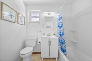 a bathroom with a toilet and a sink and a shower at Modern and Spacious House Pittsburgh in Pittsburgh +34 photos