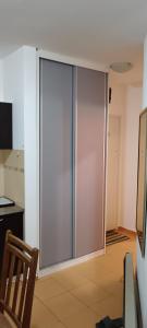 a sliding glass door in a room with a kitchen at Apartman SAN in Soko Banja +8 photos