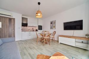 a kitchen and living room with a table and chairs at Apartment Emma complex Carpe Diem Balchik in Balchik