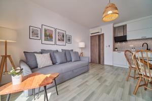 a living room with a couch and a table at Apartment Emma complex Carpe Diem Balchik in Balchik +9 photos