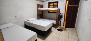 a room with two bunk beds and a window at Hotel Embaixador de Curitiba in Curitiba