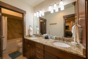 a bathroom with two sinks and a large mirror at Minutes to Deer Valley and Park City, Private Hot Tub, Mountain Views, Living + Family, More in Heber City +31 photos