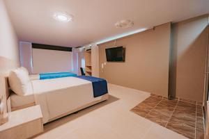 Postel nebo postele na pokoji v ubytování HOTEL VERANO