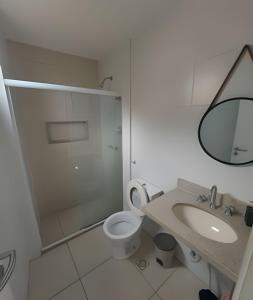 a bathroom with a toilet and a sink and a mirror at lindo apart. rio de janeiro recreio dos bandeirantes in Rio de Janeiro +7 photos