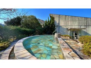 a swimming pool with colorful tiles on the side of a building at Miki no Sato Hotel Miki - Vacation STAY 52488v in Gero