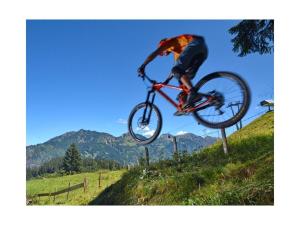 a man doing a trick on a bike in the air at Pura Vida - holiday apartment in Fischen +7 photos
