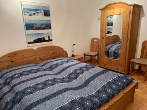 a bedroom with a wooden bed and a mirror at Nice holiday home near the centre in Duhnen