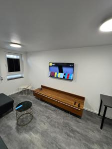 a living room with a couch and a flat screen tv at Luxus-Apartment im Herzen von Ludwigsburg in Ludwigsburg