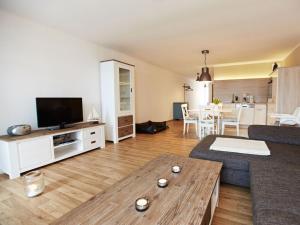 a living room with a couch and a table at Strandeck Comfortable holiday residence in Göhren
