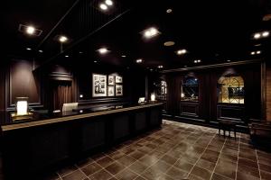 a restaurant with a bar in a dark room at The Italia Ken in Niigata