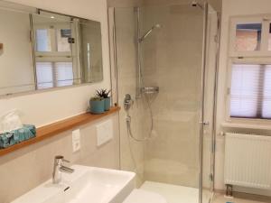 a bathroom with a glass shower and a sink at to the lakeside promenade in Überlingen