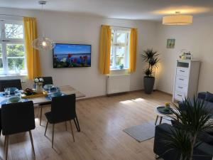 a living room with a table and a dining room at to the lakeside promenade in Überlingen