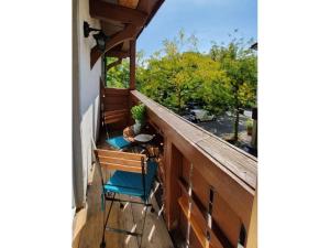 a balcony with two chairs and a table at to the lakeside promenade in Überlingen