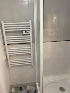 a shower with a glass door in a bathroom at Joli studio centre ville de Dole in Dole