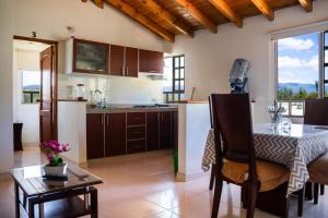 a kitchen with a table and a dining room at Villa Libertad Campestre in Paipa