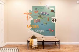 a map of africa on a wall in a room with a bench at Flagstaff Route 66 Retreat in Flagstaff