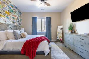 a bedroom with a bed and a flat screen tv at Flagstaff Route 66 Retreat in Flagstaff