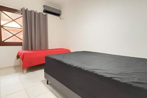 Ένα ή περισσότερα κρεβάτια σε δωμάτιο στο Casa de condomínio em Maresias - SP (5) +32 φωτογραφίες