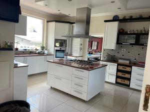 a large kitchen with white cabinets and a stove at The Beach Residence in Swakopmund