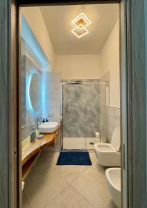 a bathroom with a shower and a sink and a toilet at A casa dei Nonni in Tramonti
