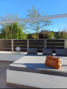 a bed with a bag sitting on top of a bedvisor at Crystal Aura in Paralia Katerinis