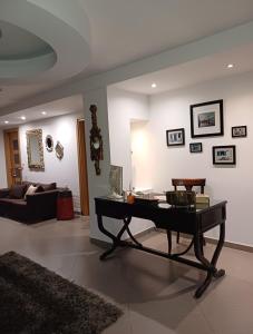 a living room with a table and a couch at Crystal Aura in Paralia Katerinis