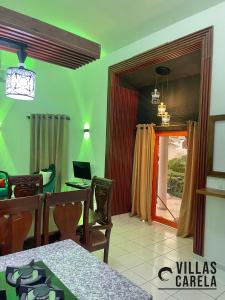 a dining room with a table and a laptop on it at Villas Carela, Villas Privadas con Piscina y Jacuzzi a 2 Minutos de la Playa de Cabarete in Cabarete