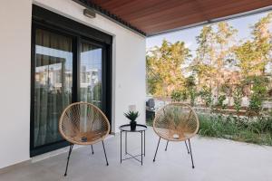 two chairs and a table on a patio at Kyan Executive Suites in Iraklitsa