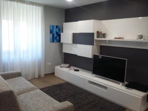 a living room with a flat screen tv and a couch at Casa abuela Gaspara I in Villalcázar de Sirga