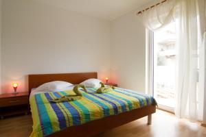 a bedroom with a bed with two rubber ducks on it at Apartment Volme in Pula