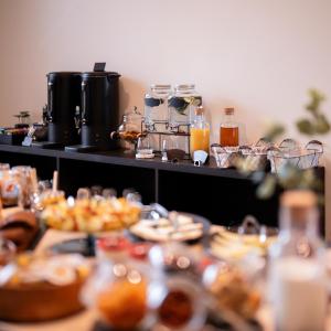 a table filled with plates of food and drinks at Star Hill Hotel in Prishtinë +50 photos