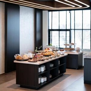 a kitchen with a table with food on it at Star Hill Hotel in Prishtinë