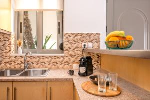 a kitchen with a sink and a bowl of fruit at Casa Kamara in Kounoupidhianá +91 photos