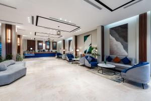 a lobby of a hospital with couches and chairs at Al Qasr Corniche in Jazan