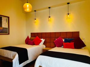 Giường trong phòng chung tại Hotel Consulado