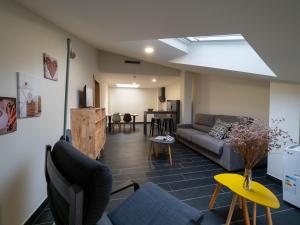 a living room with a couch and a table at Lumen Place APARTAMENTOS in Mondoñedo